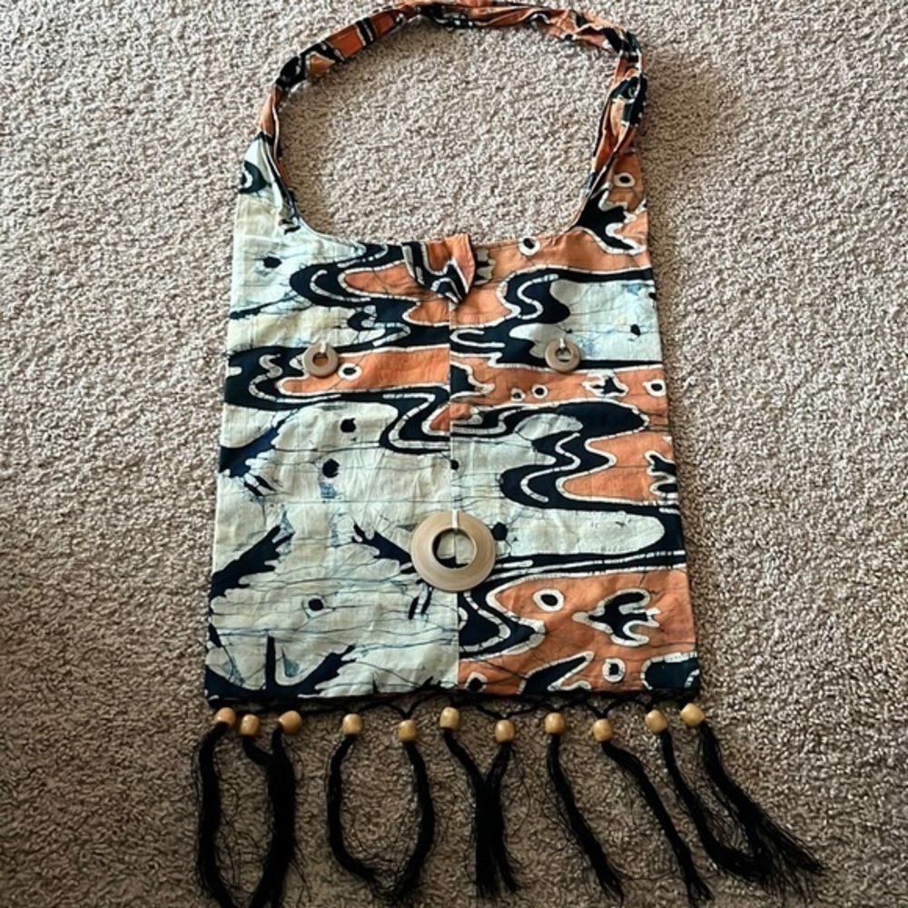 Tribal cloth handbag with wooden beads and black tassels